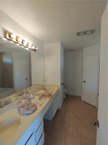 a bathroom with a sink double vanity and a mirror