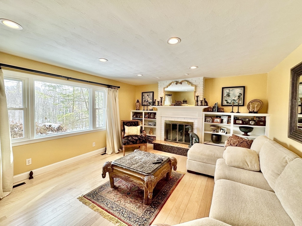 629 Florence Road Northampton, MA 01062 - Photo 25 of 36 a living room with furniture large window and a fireplace