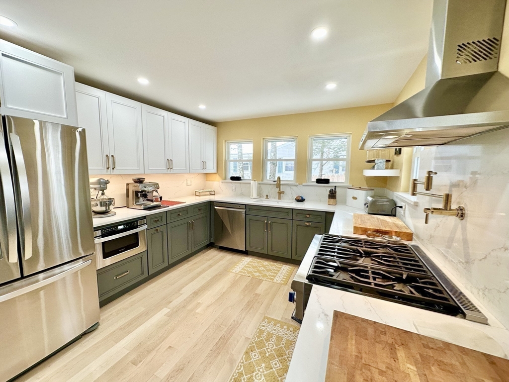 629 Florence Road Northampton, MA 01062 - Photo 4 of 36 a kitchen with stainless steel appliances granite countertop a stove a sink dishwasher a refrigerator and white cabinets with wooden floor