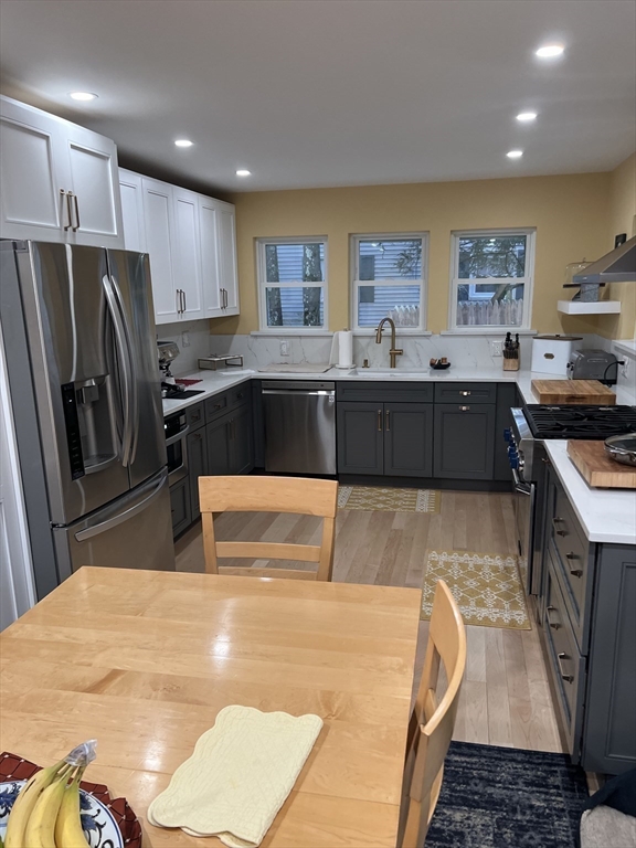 629 Florence Road Northampton, MA 01062 - Photo 8 of 36 a kitchen with stainless steel appliances kitchen island granite countertop a refrigerator a sink a stove with wooden cabinets