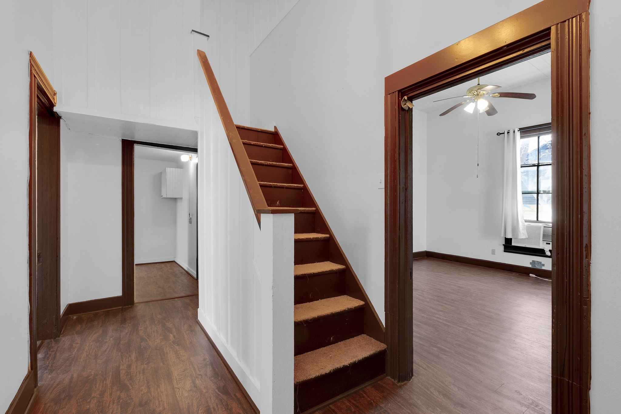2705 East 2nd Street Austin, TX 78702 - Photo 8 of 36 Step through the front door into a foyer that immediately sets the tone with its high ceilings and natural light The entryway’s staircase leads you up to the second floor, offering a graceful transition to the guest bedrooms