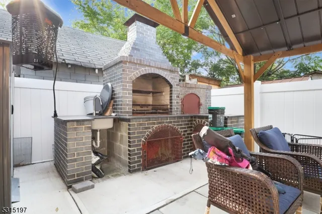 a view of a patio with couches chairs and backyard of a house