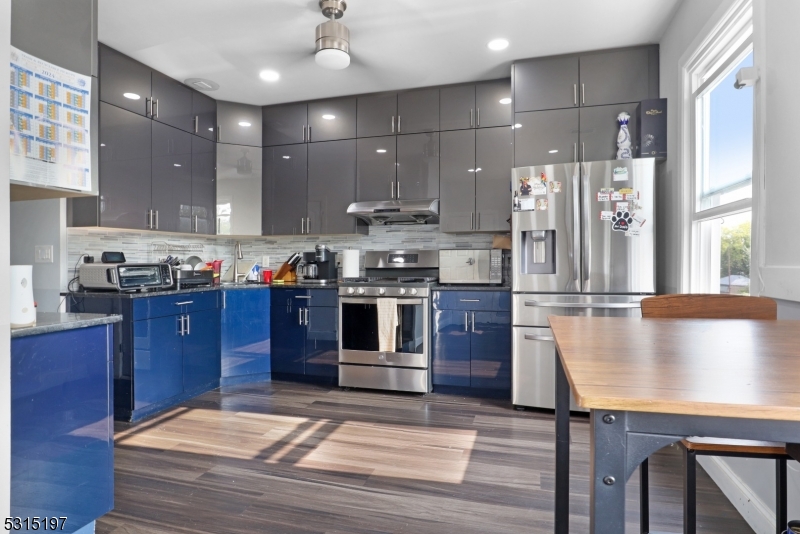 737 Jackson Avenue, Unit 2 Elizabeth, NJ 07201 - Photo 3 of 14 a kitchen with stainless steel appliances granite countertop a stove a sink and a refrigerator