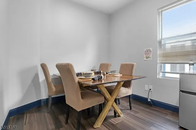 a view of a workspace with furniture and wooden floor