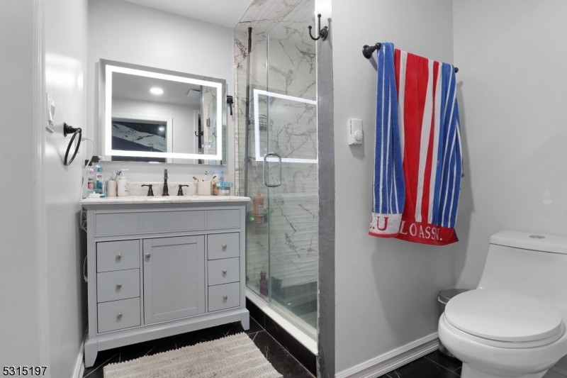 737 Jackson Avenue, Unit 2 Elizabeth, NJ 07201 - Photo 8 of 14 a bathroom with a sink a toilet and a mirror