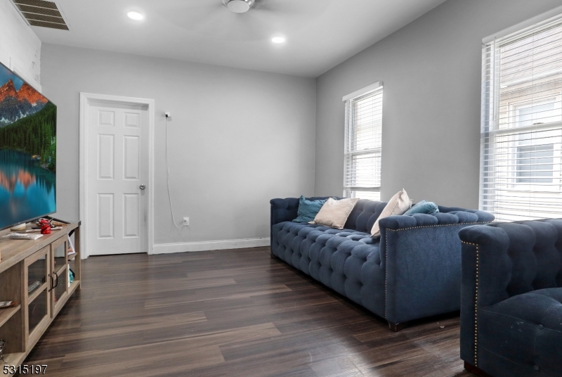 737 Jackson Avenue, Unit 2 Elizabeth, NJ 07201 - Photo 10 of 14 a living room with furniture a flat screen tv and a window