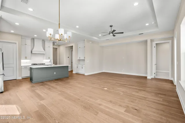 a view of a kitchen with a sink hardwood floor and a ceiling fan