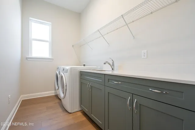 a utility room with a sink dryer and washer