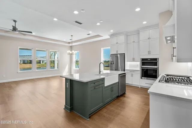 a kitchen with stainless steel appliances granite countertop a stove and a sink