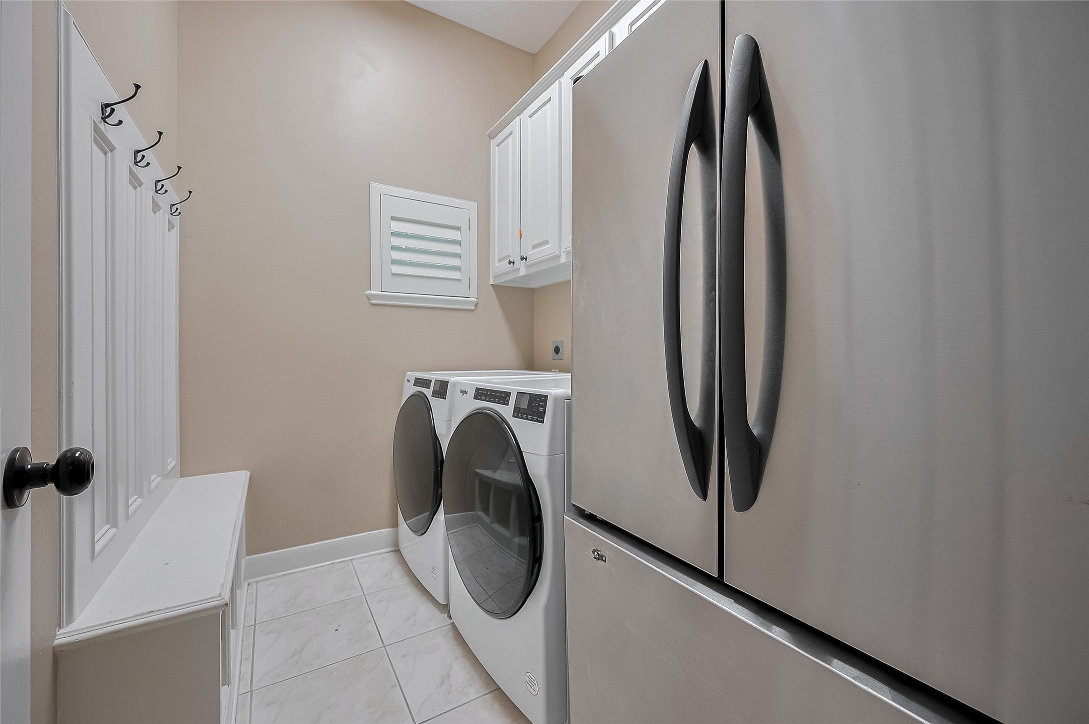 11826 Legend Manor Drive Houston, TX 77082 - Photo 20 of 43 Custom bench and cabinets here in the home's utility room. NOTE: Washer/Dryer included. This 2nd refrigerator is NOT included, but space available for additional storage.