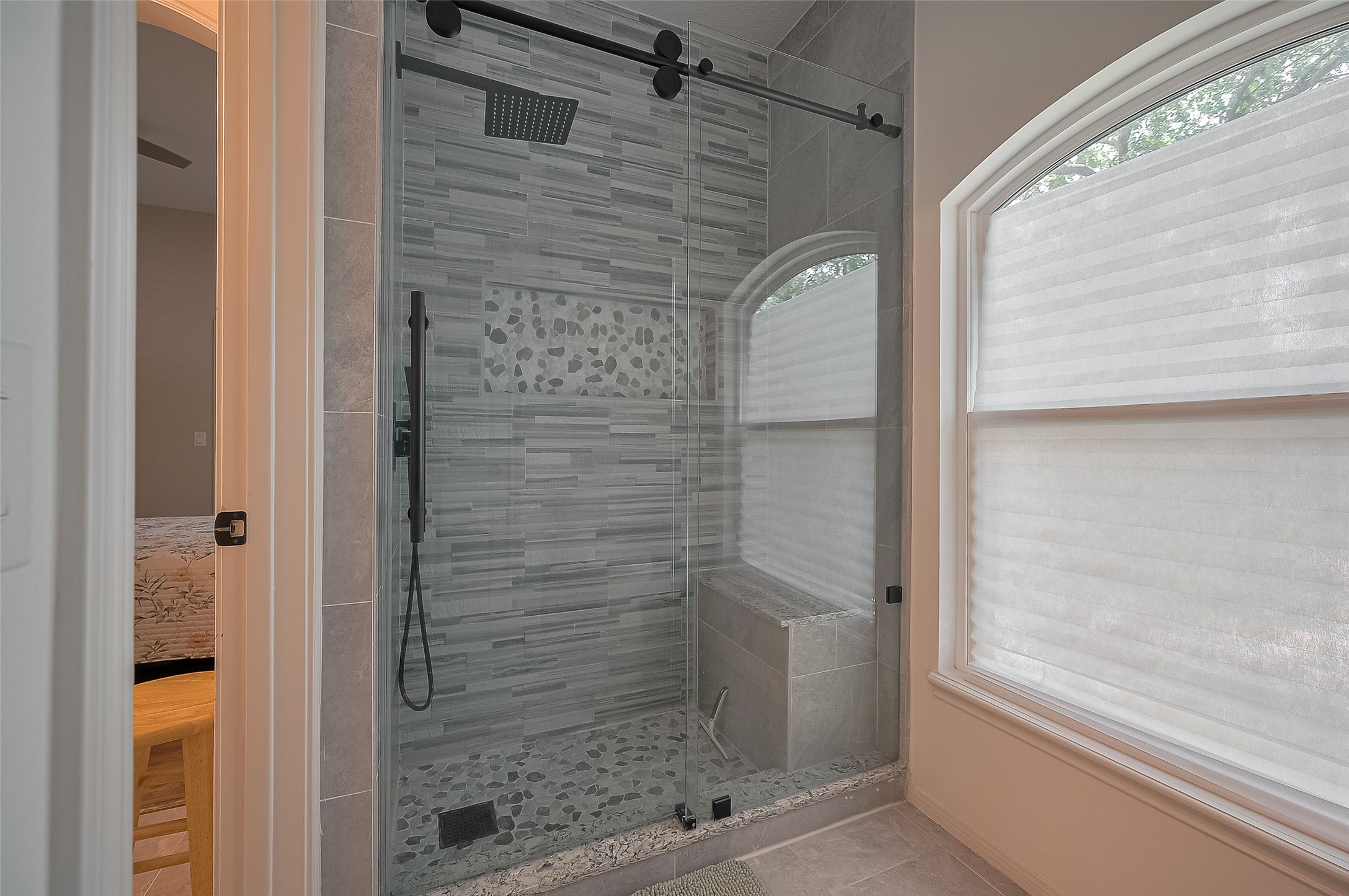 11826 Legend Manor Drive Houston, TX 77082 - Photo 24 of 43 "Barn Door" frameless glass shower with bench, stunning tile, a rain shower head as well as a shower wand.