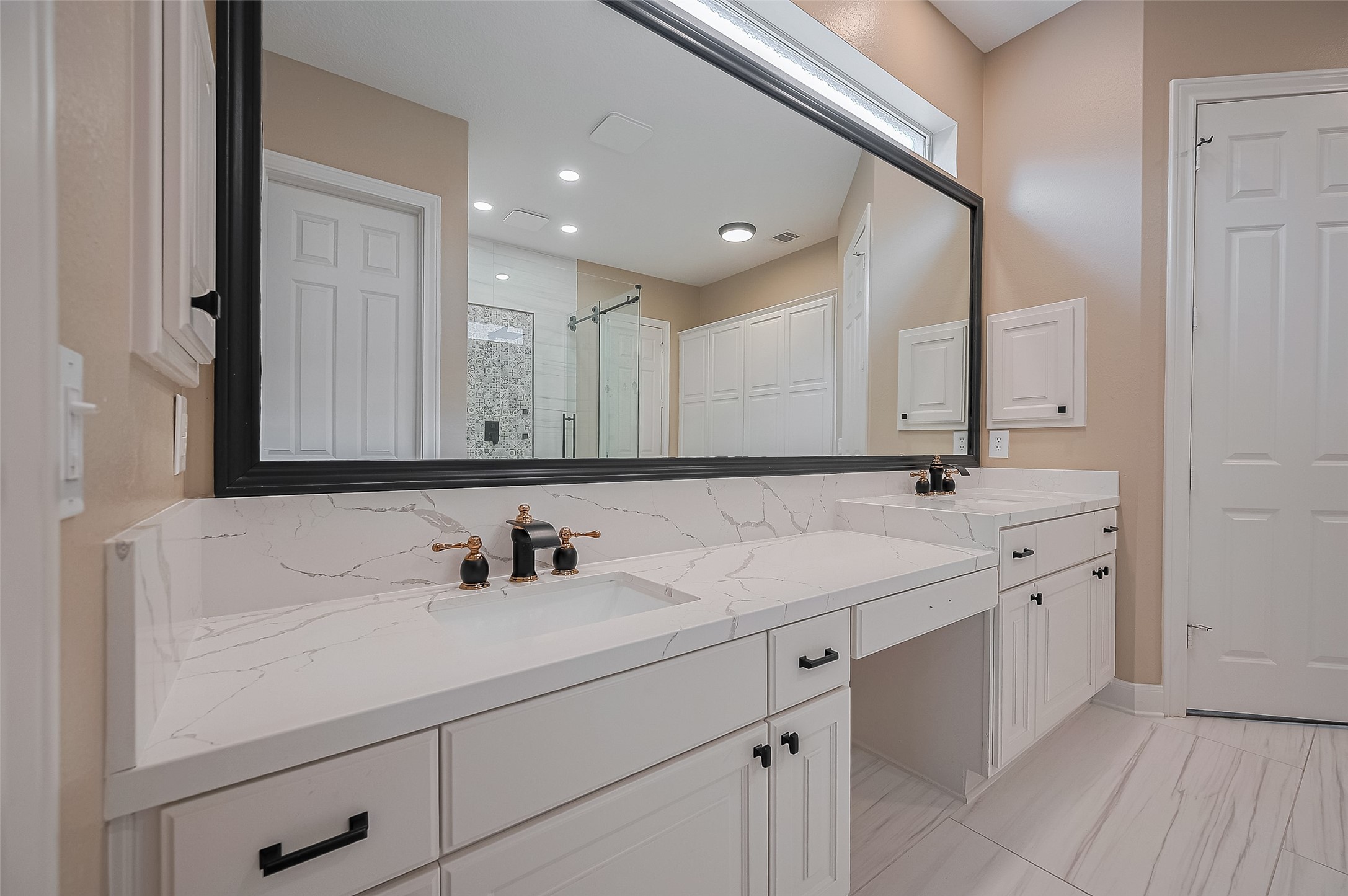 11826 Legend Manor Drive Houston, TX 77082 - Photo 33 of 43 Elegant ensuite primary bathroom with dual sinks, quartz counters and a vanity area.