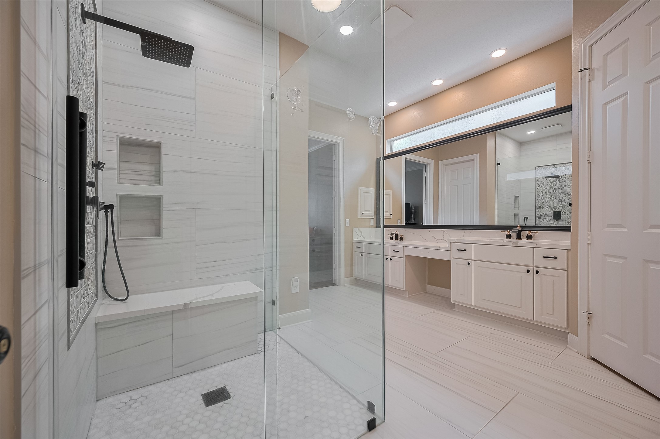 11826 Legend Manor Drive Houston, TX 77082 - Photo 35 of 43 Spacious, quartz accents and oversized tile in this walk-in shower. Hand wand, multi-head sprayers as well as rain shower head. NOT SHOWN: In addtion, a free standing tub going in Nov/2025.