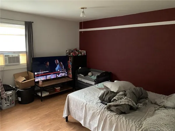a bed sitting in a bedroom next to a window