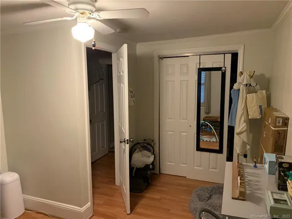 a bathroom with a granite countertop sink a toilet and a mirror