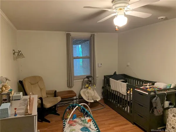 a bedroom with furniture and a chandelier