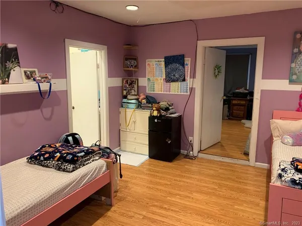 a kitchen with stainless steel appliances a stove a refrigerator and a dining table