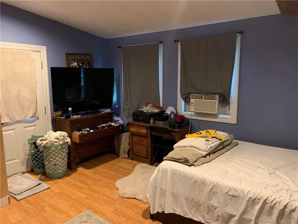 a bedroom with a bed and dresser