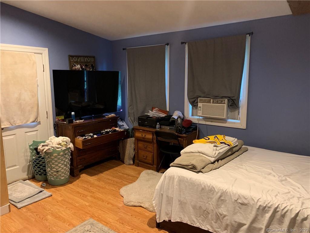 15 Spring Hill Avenue Norwalk, CT 06850 - Photo 2 of 18 a bedroom with a bed and dresser