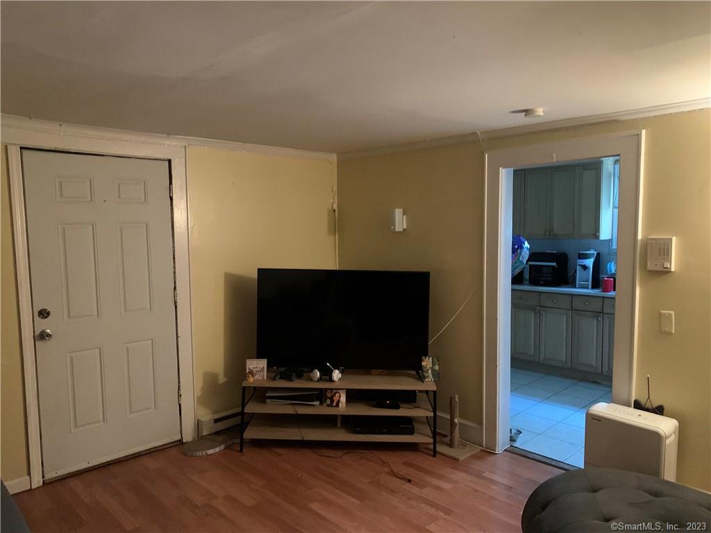 15 Spring Hill Avenue Norwalk, CT 06850 - Photo 6 of 18 a living room with furniture and a flat screen tv