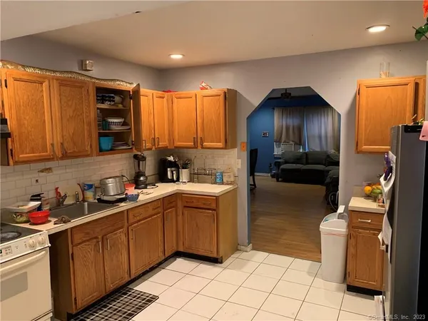 a kitchen with stainless steel appliances a sink cabinets and wooden floor