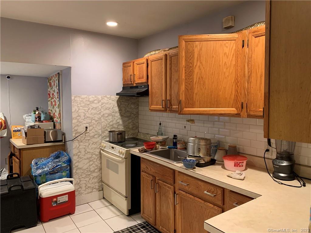 15 Spring Hill Avenue Norwalk, CT 06850 - Photo 9 of 18 a kitchen with stainless steel appliances a stove a sink and cabinets