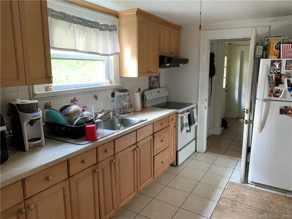 a kitchen with a sink cabinets and window
