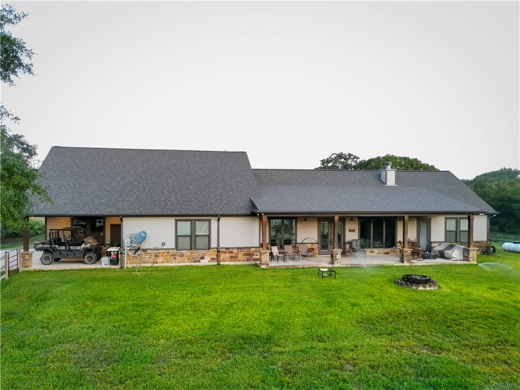 17497-495 Wilson Pasture Road Bryan, TX 77808 - Photo 14 of 50 a front view of a house with a garden and trees
