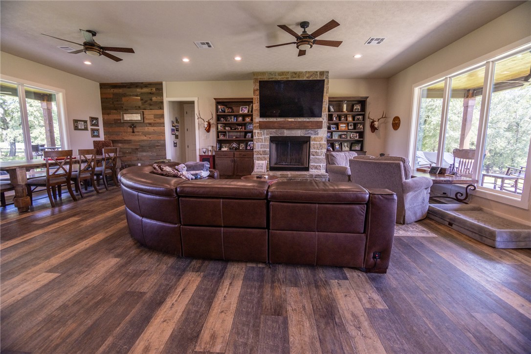 17497-495 Wilson Pasture Road Bryan, TX 77808 - Photo 20 of 50 a living room with furniture a flat screen tv and a fireplace