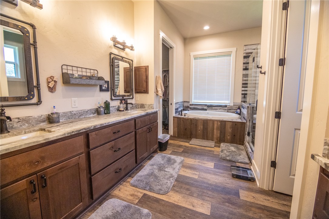 17497-495 Wilson Pasture Road Bryan, TX 77808 - Photo 26 of 50 a spacious bathroom with double vanity and a mirror