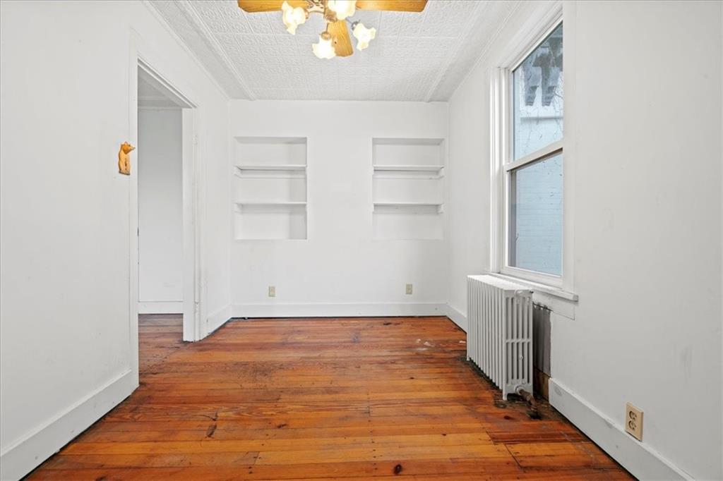 1947 South 18th Street Pittsburgh, PA 15203 - Photo 5 of 48 a view of an empty room with wooden floor and a window