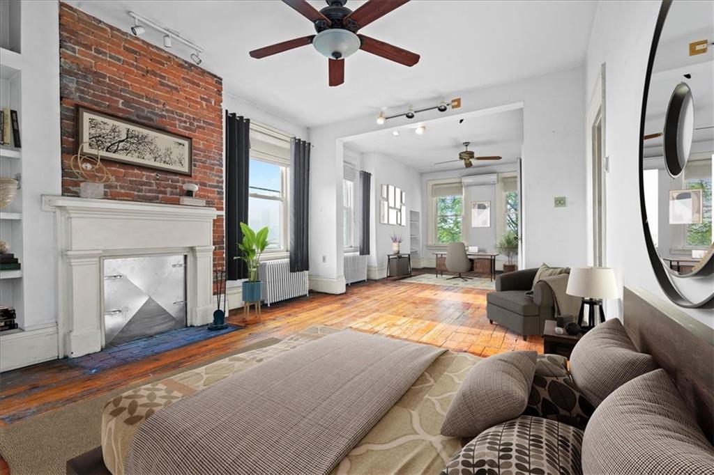 1947 South 18th Street Pittsburgh, PA 15203 - Photo 7 of 48 a bed room with a bed a mirror and a fireplace