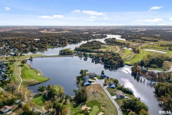 an aerial view of a house with a lake view