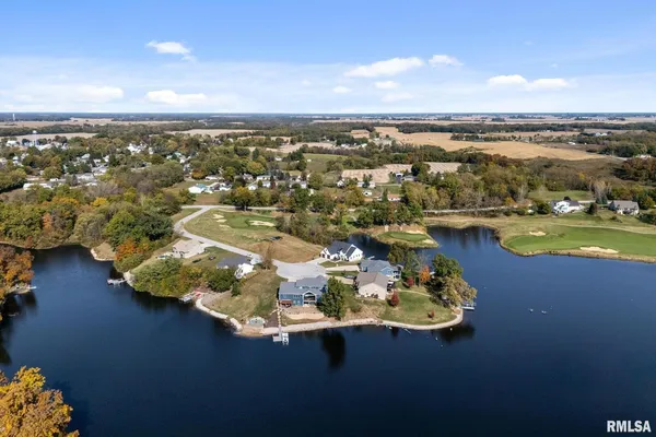 a view of a lake with houses in the back