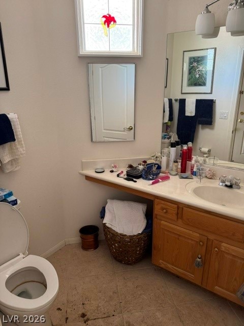 589 Beacon Ridge Way Mesquite, NV 89027 - Photo 16 of 18 A well-lit bathroom with a bright window, a spacious vanity, and practical tile flooring.
