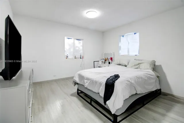 a view of a livingroom with workspace and a window