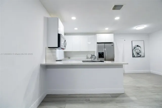 a kitchen with a refrigerator sink and stove