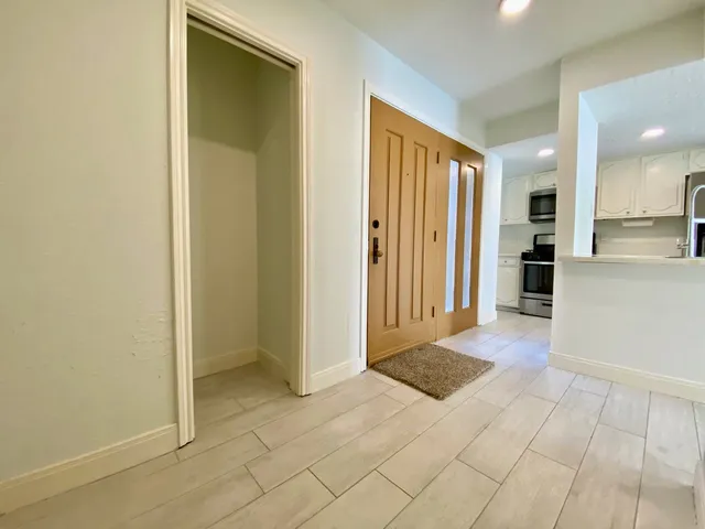 a view of a hallway with bathroom and bathroom