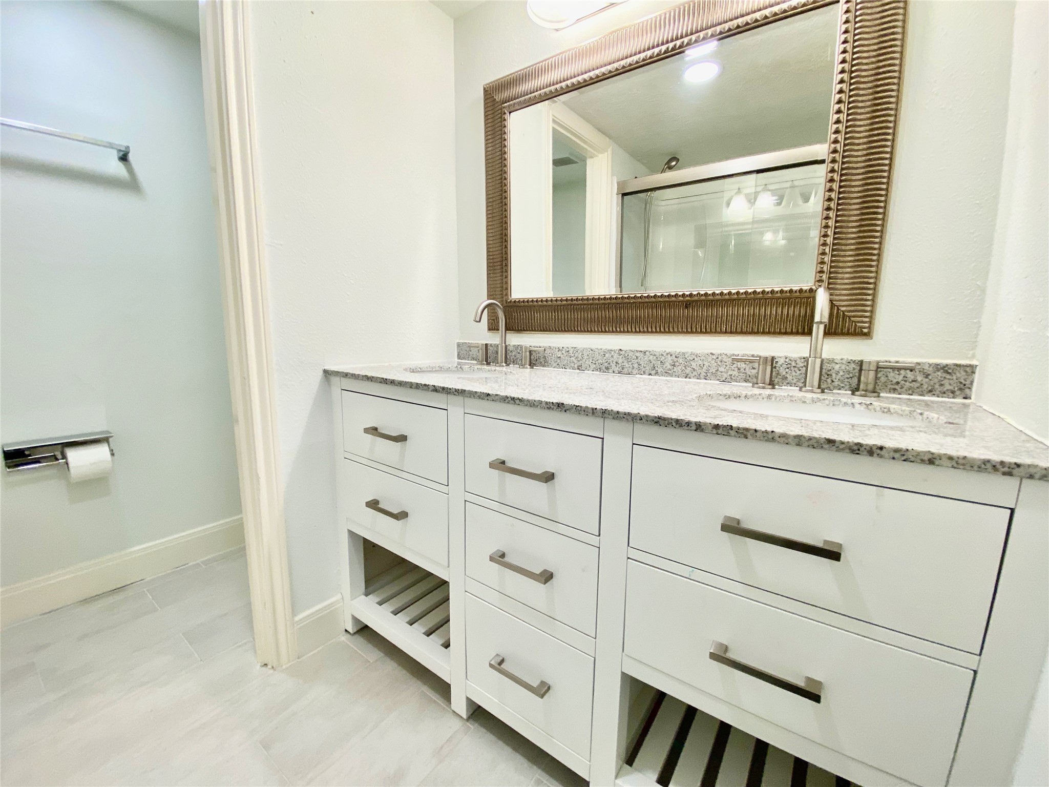 1259 Blalock Road Houston, TX 77055 - Photo 28 of 41 a bathroom with a granite countertop sink vanity and mirror