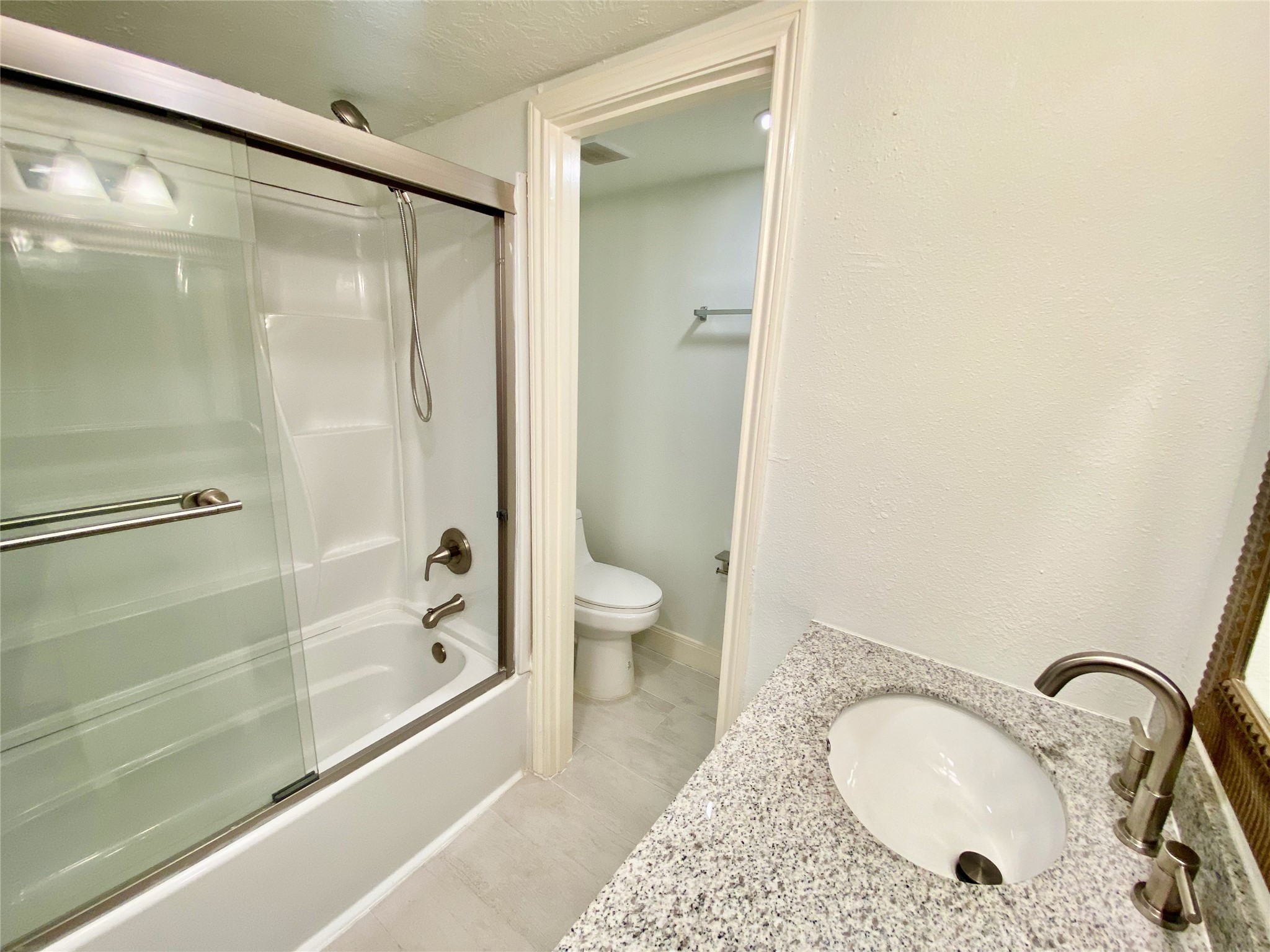 1259 Blalock Road Houston, TX 77055 - Photo 30 of 41 a bathroom with a granite countertop sink toilet and shower