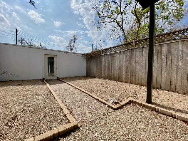 a view of a house with a big yard and large trees