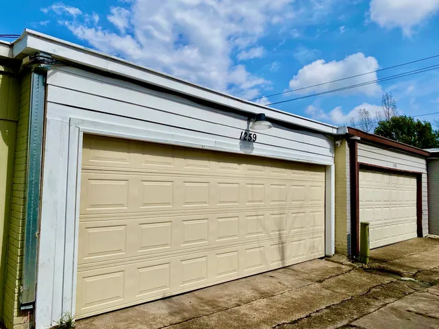 a view of a house with a big yard plants and large trees