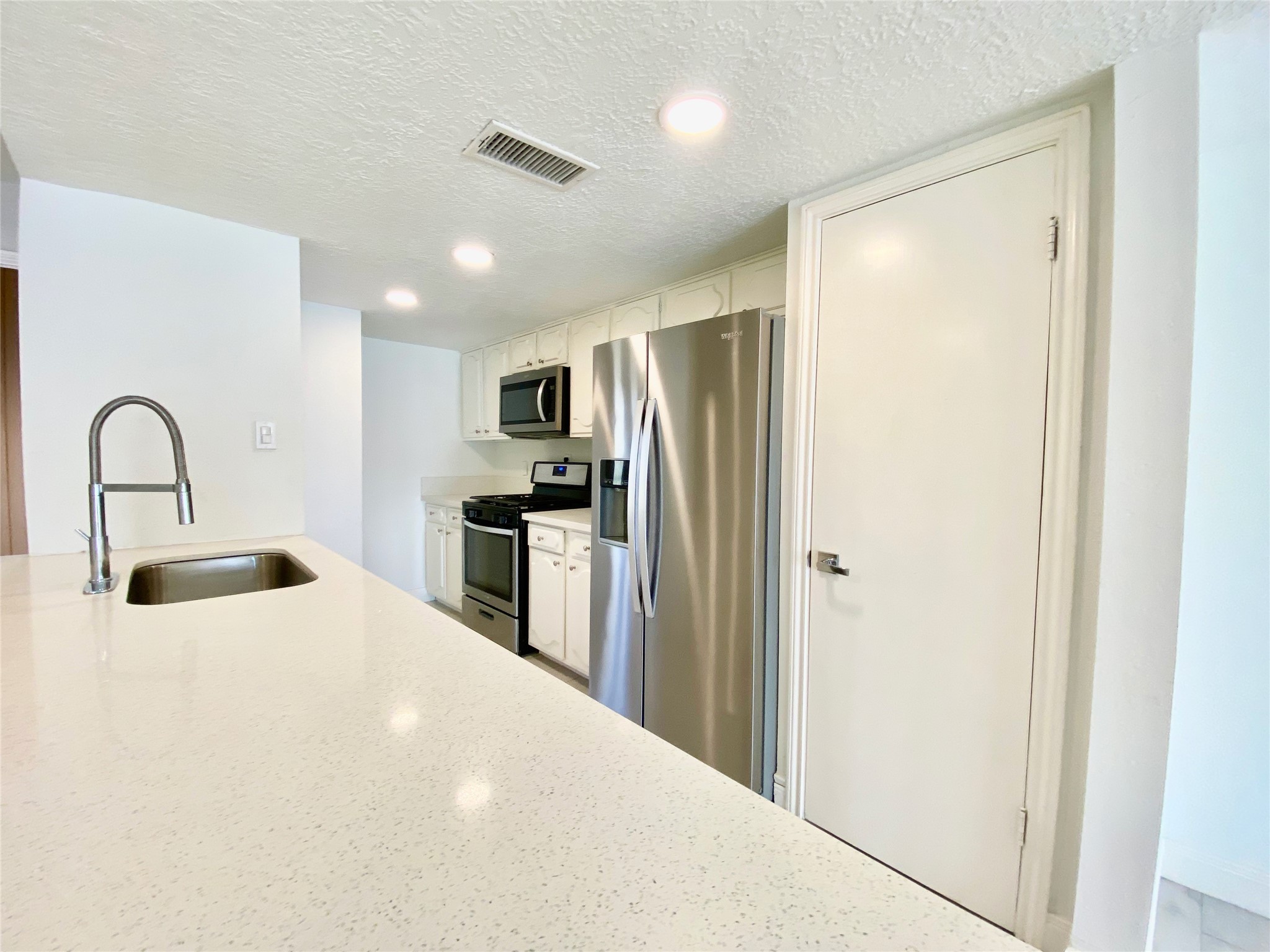 1259 Blalock Road Houston, TX 77055 - Photo 8 of 41 a kitchen with a refrigerator and a sink