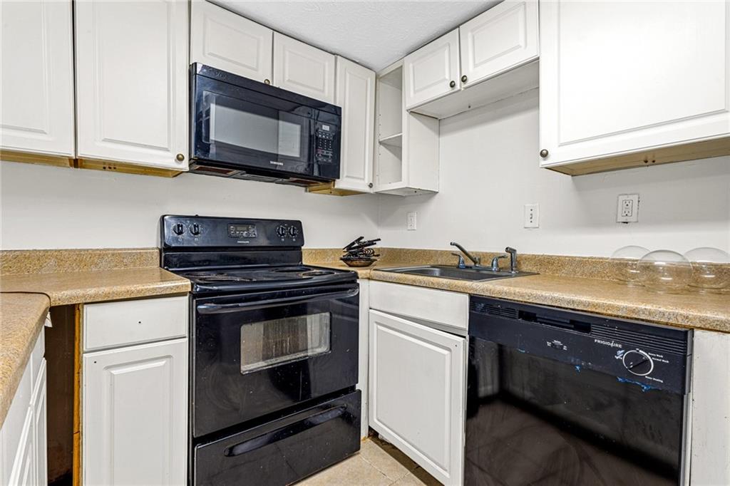3451 Cobbs Ferry Drive Decatur, GA 30032 - Photo 3 of 21 a kitchen with stainless steel appliances granite countertop a sink a stove a microwave oven and cabinets
