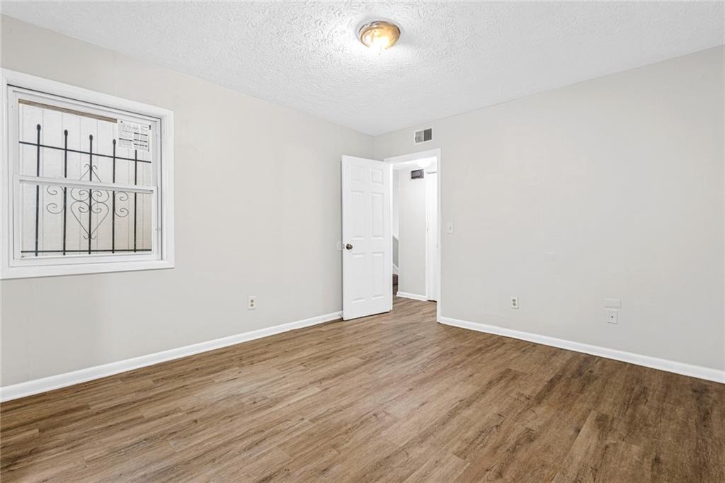 3451 Cobbs Ferry Drive Decatur, GA 30032 - Photo 9 of 21 a view of an empty room with wooden floor and a window