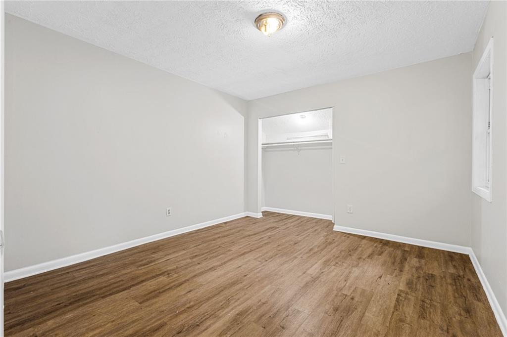 3451 Cobbs Ferry Drive Decatur, GA 30032 - Photo 10 of 21 an empty room with wooden floor and windows