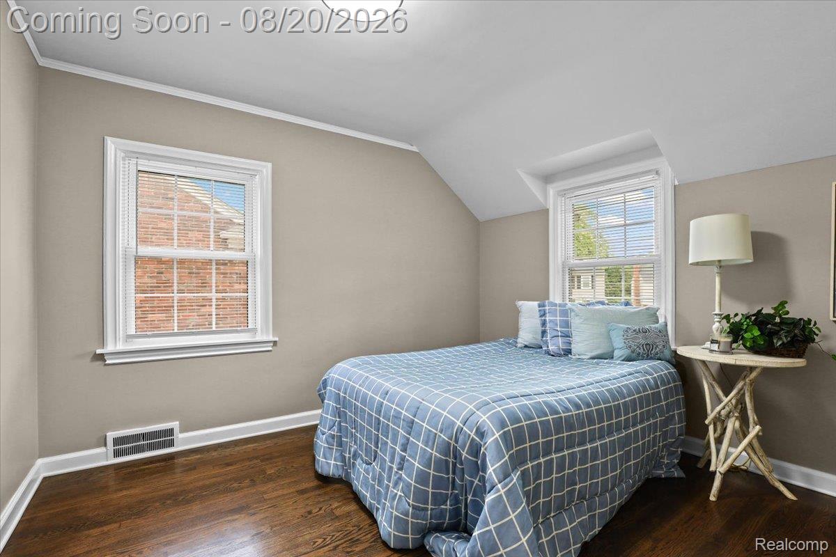 429 Moran Road Grosse Pointe, MI 48236 - Photo 24 of 36 Bright upper-level bedroom featuring hardwood flooring, sloped ceilings with recessed lighting, and two double-hung windows with white trim providing natural light