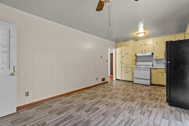 a view of a refrigerator in kitchen and wooden floor
