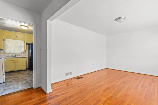 a view of a room with wooden floor and a sink
