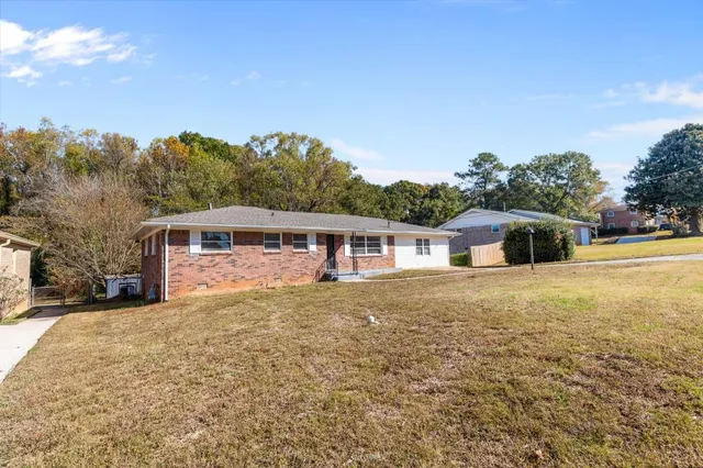 a front view of a house with a garden
